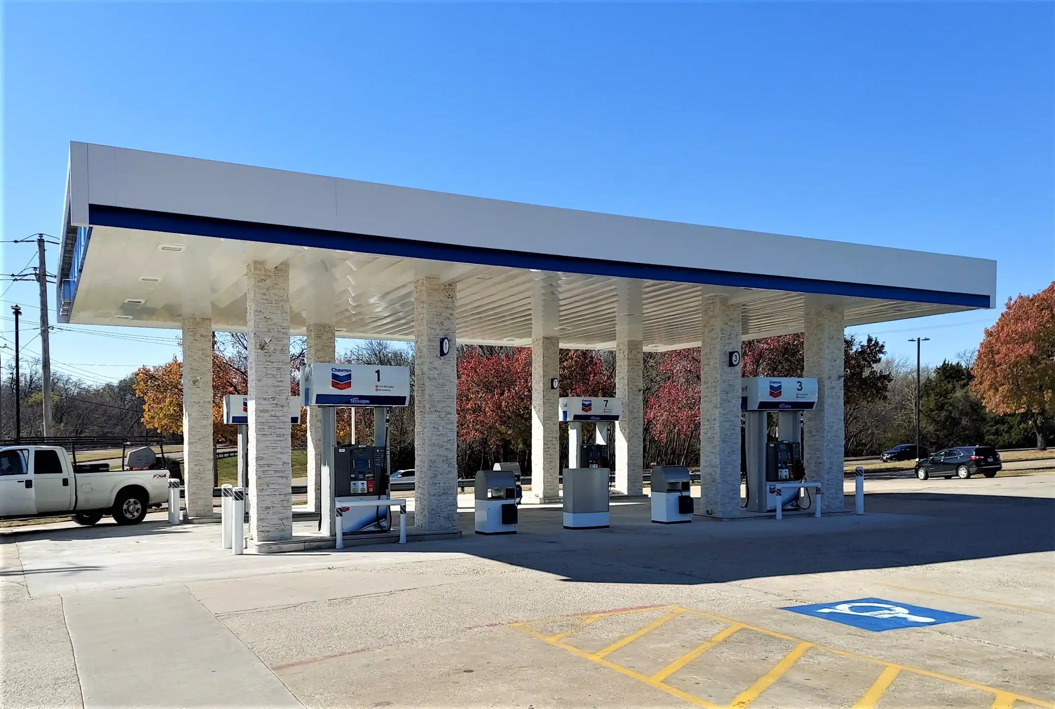 Newly built Chevron fueling canopy with three dispensers on a finished concrete forecourt